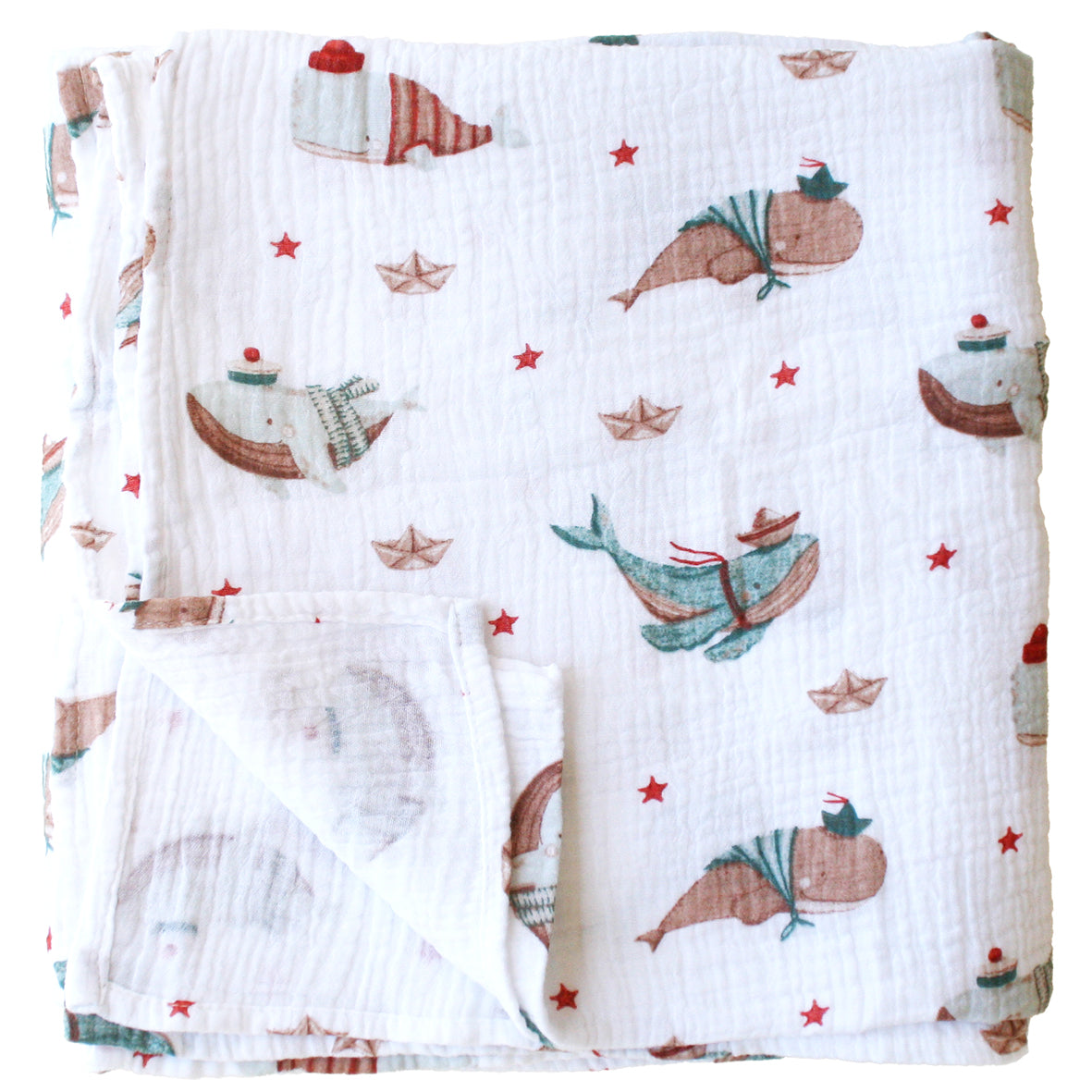 White muslin swaddle blanket with playful whales and red starfish pattern.