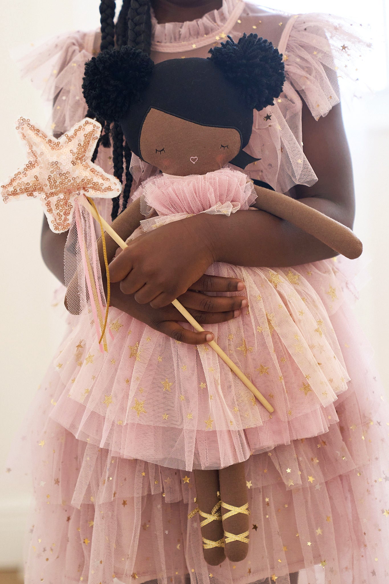 Alimrose Halle Ballerina Doll with dark brown skin and pom-pom yarn hair, dressed in a sparkly tulle dress.