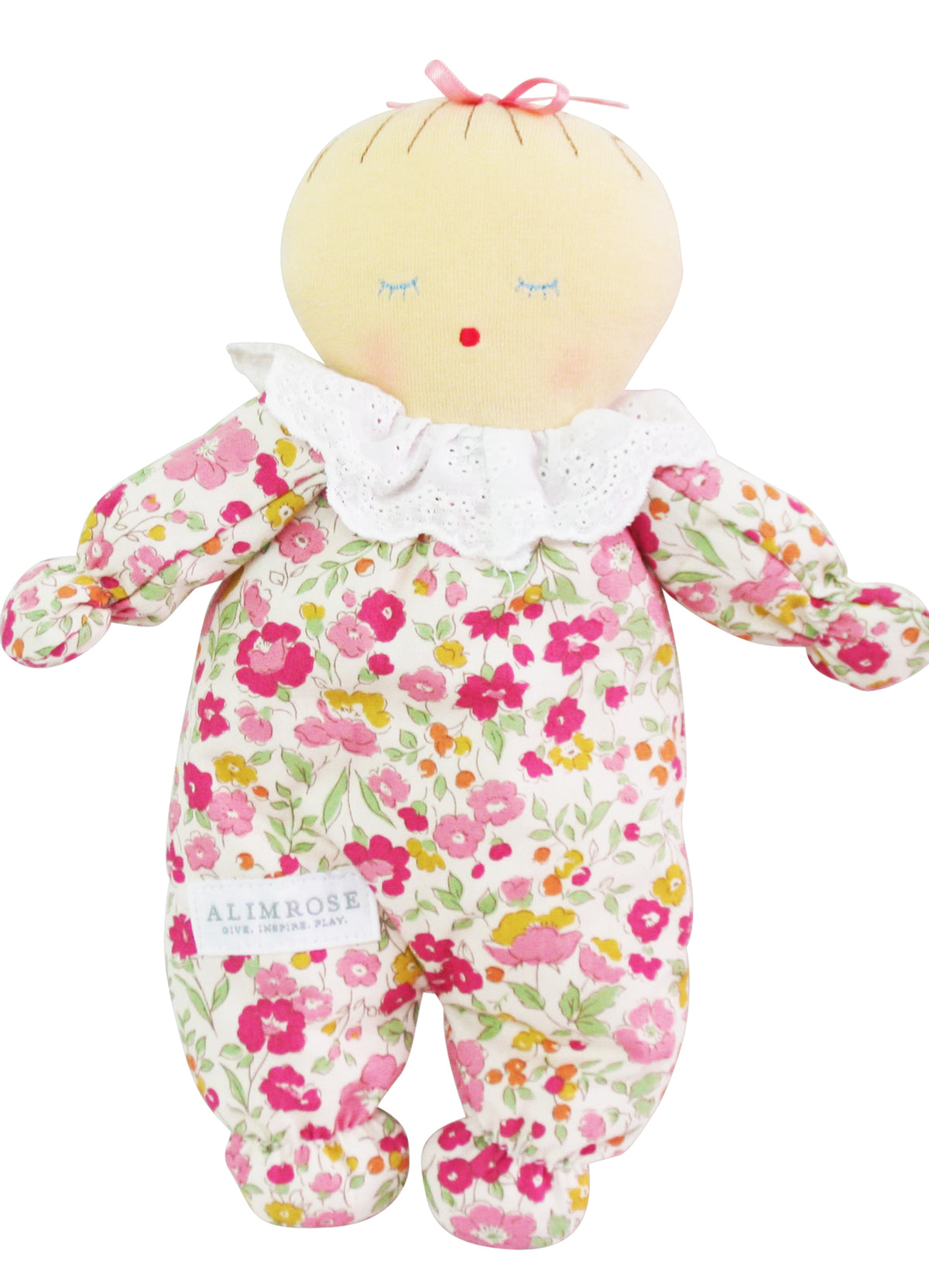 Soft fabric doll in floral rose garden print romper with white ruffled collar and pink bow on head.