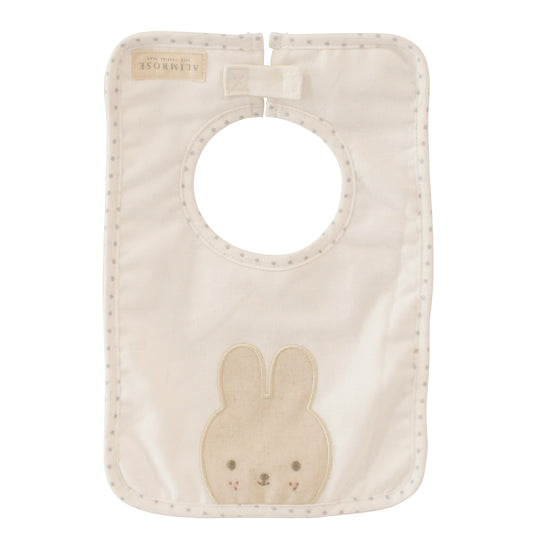 Ivory linen bunny bib with cute bunny appliqué and embroidered face, perfect for mealtime with little ones.