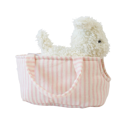 White fluffy plush puppy sitting inside a soft pink and white striped fabric carrier with handles.