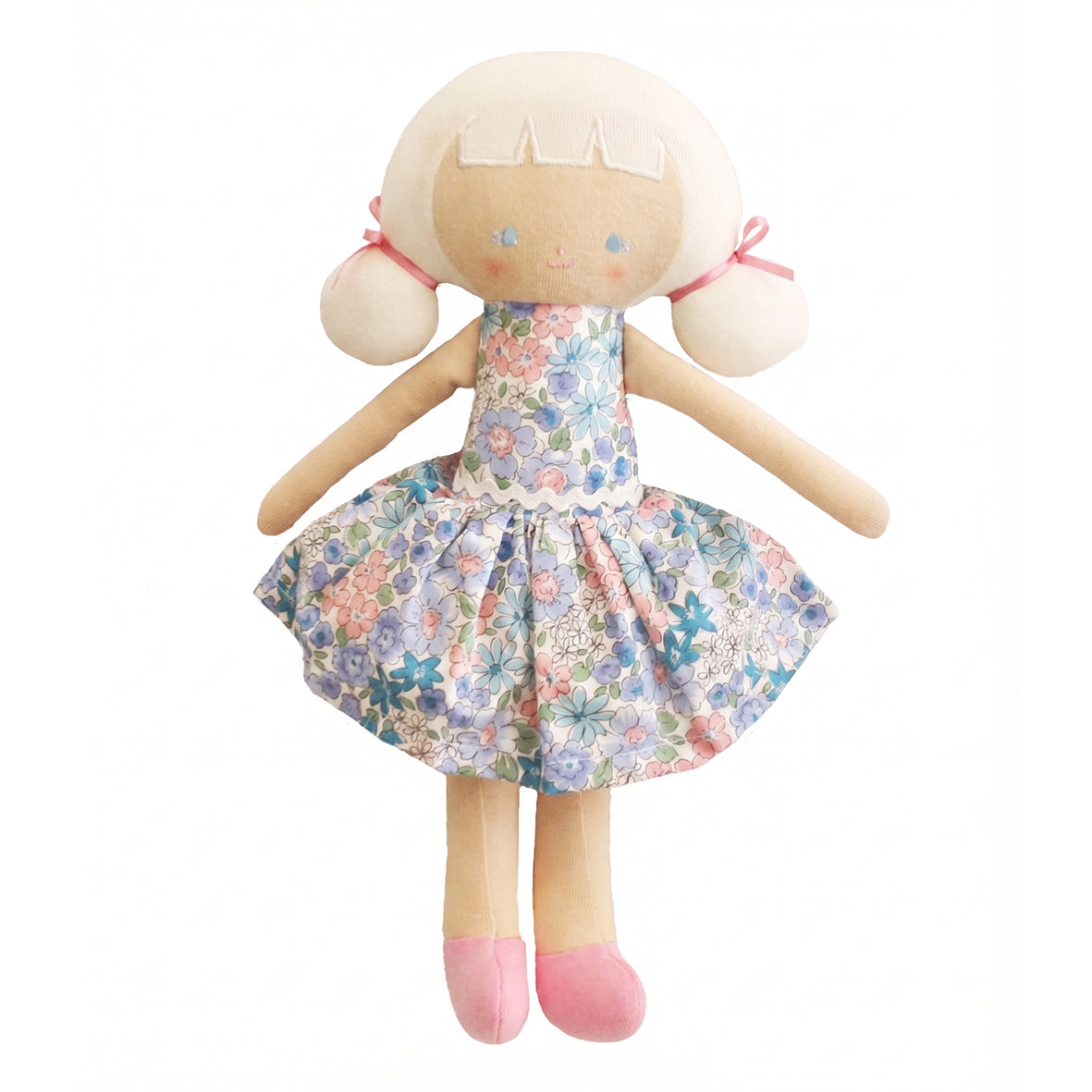Soft fabric doll with pale skin, blonde hair tied with pink bows, wearing a blue floral dress and pink shoes.