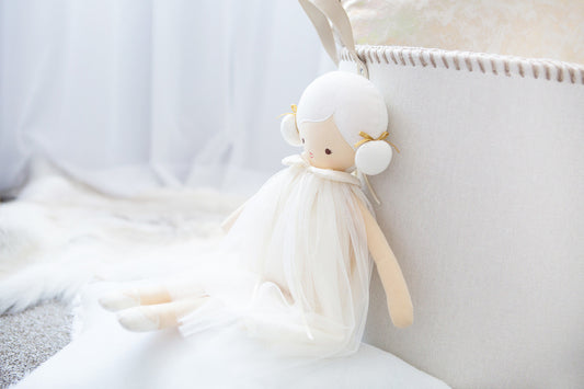 Lulu Doll 48cm in ivory dress with cute buns, promoting imaginative play for children.