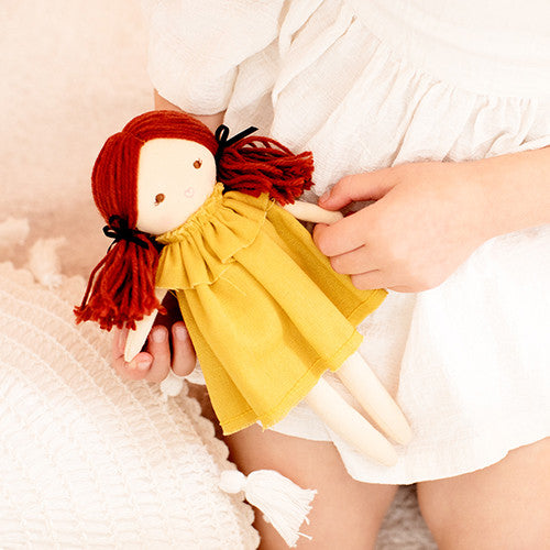 Mini Matilda doll with red hair in a removable butterscotch frock, perfect for imaginative play and social skill development.