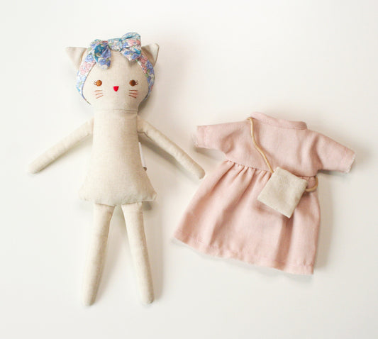 Cute Mini Lilly Kitty doll in pink linen dress with removable outfit and floral headband, perfect for playdates.