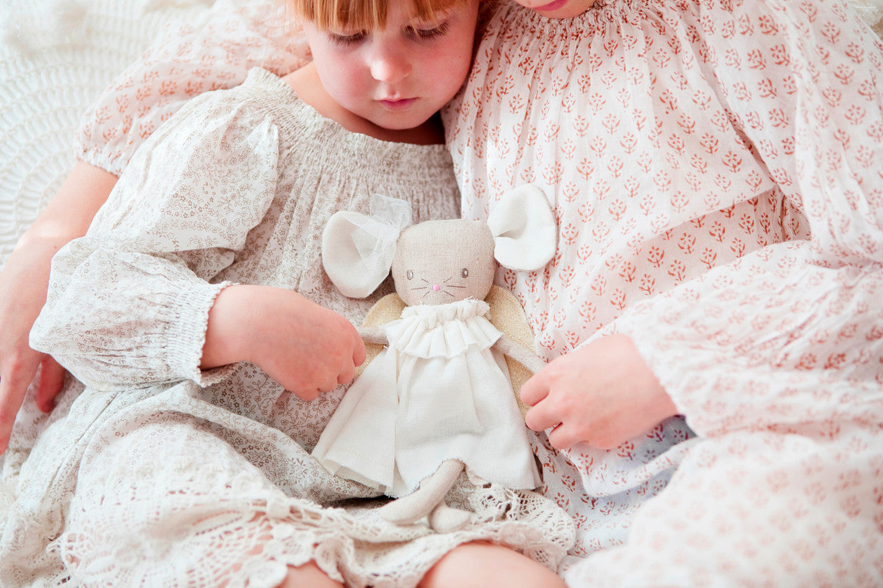 Children cuddling an Angel Baby Mouse toy in ivory and gold, featuring linen dress and sparkly wings.
