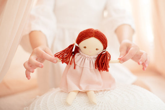 Mini Matilda 24cm pink doll with red hair, dressed in a removable pink frock for imaginative play.