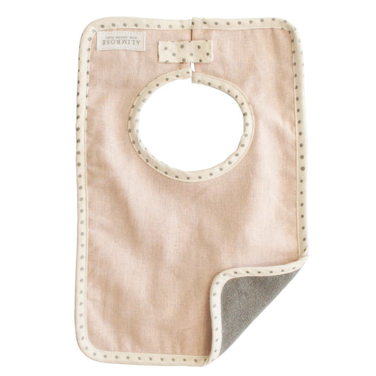 Alimrose Bobby Bib in pink linen, handcrafted with absorbent backing for stylish mealtime comfort.
