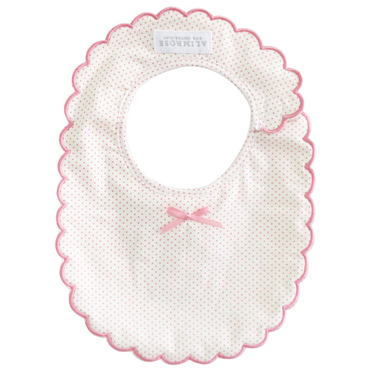 Alimrose Scallop Bib Spot Pink, cotton bib with embroidered edges and pink bow, perfect for stylish baby outfits.