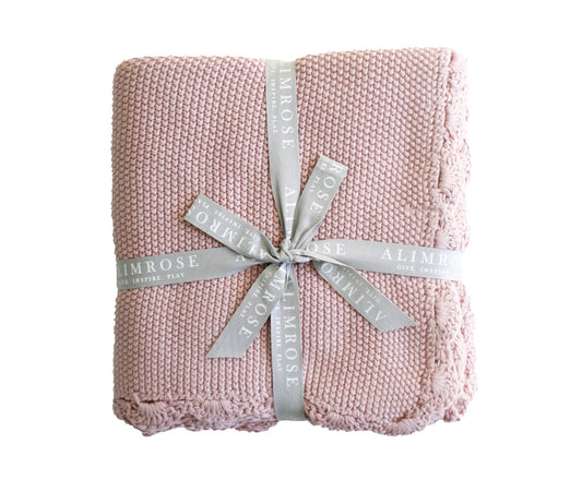 Knit mini moss stitch baby blanket in petal pink, 100% cotton, featuring scallop edge, machine washable.
