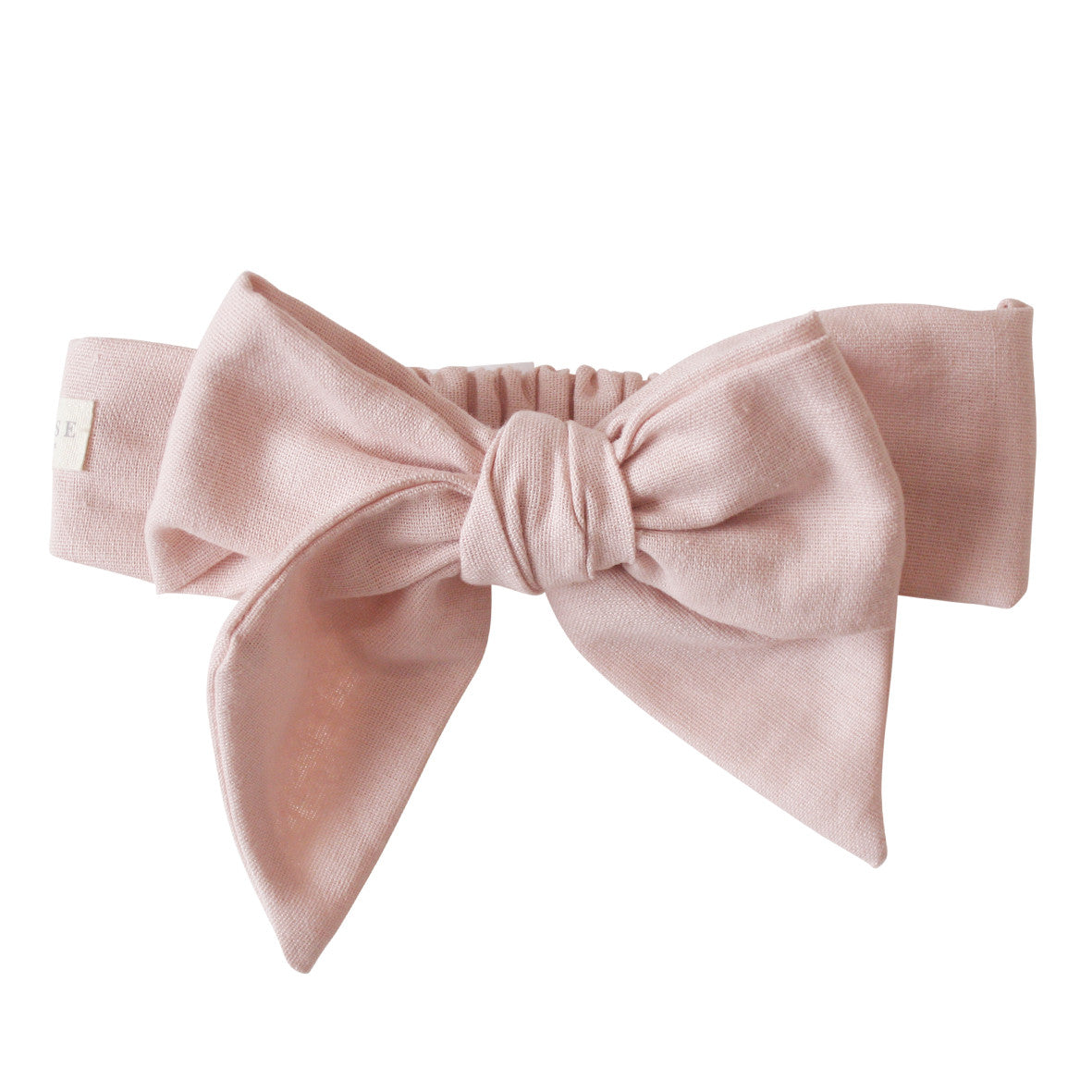Adjustable pink linen head bow for toddlers, featuring encased elastic for comfort and flexibility.