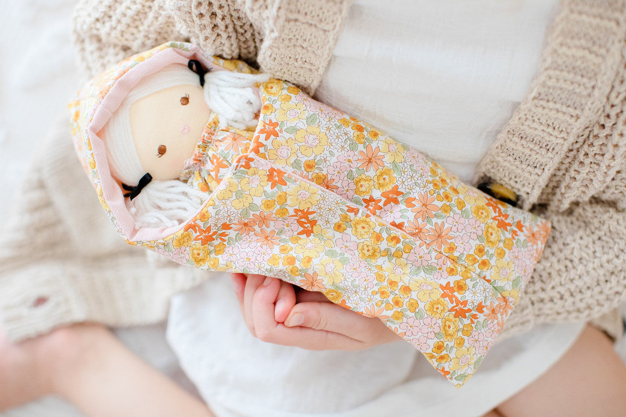 Mini Matilda doll in floral sleeping bag, featuring cute embroidered face, perfect for ages 3 and up.