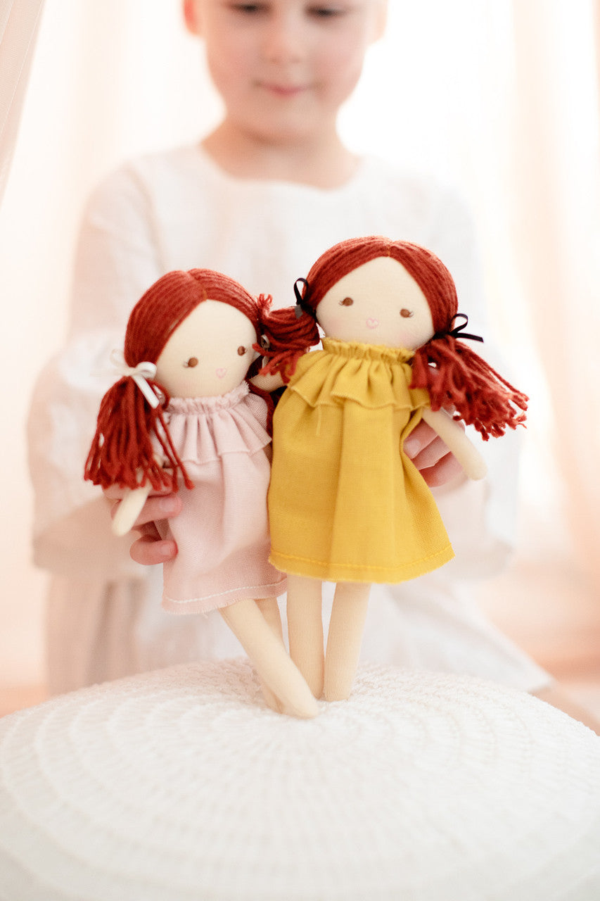Adorable Mini Matilda dolls in pink and yellow dresses, ideal for imaginative play and social skill development.