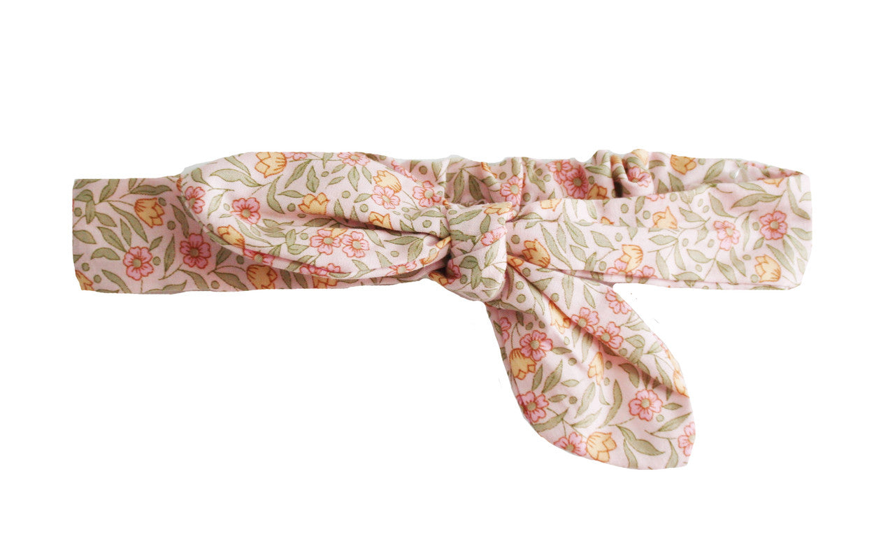 Adjustable head bow in pink floral pattern, 100% cotton, suitable for babies up to 2 years, machine washable.