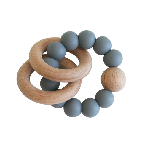 Beechwood teether ring in storm grey with soft silicone beads, perfect for soothing sore gums of babies.