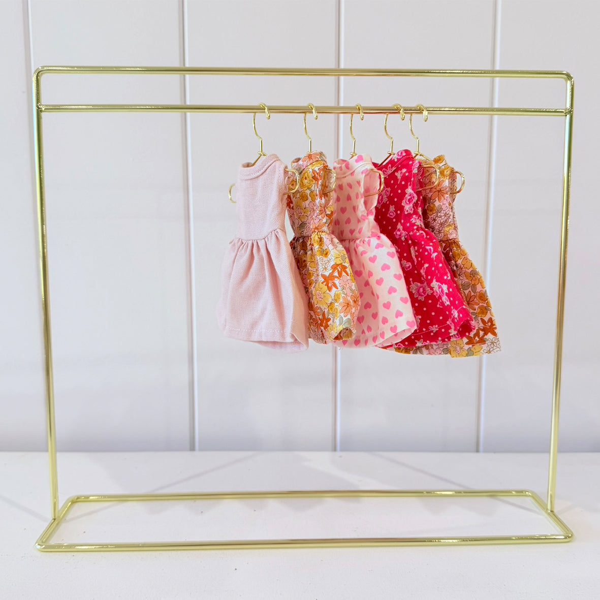 a rack with dresses on it