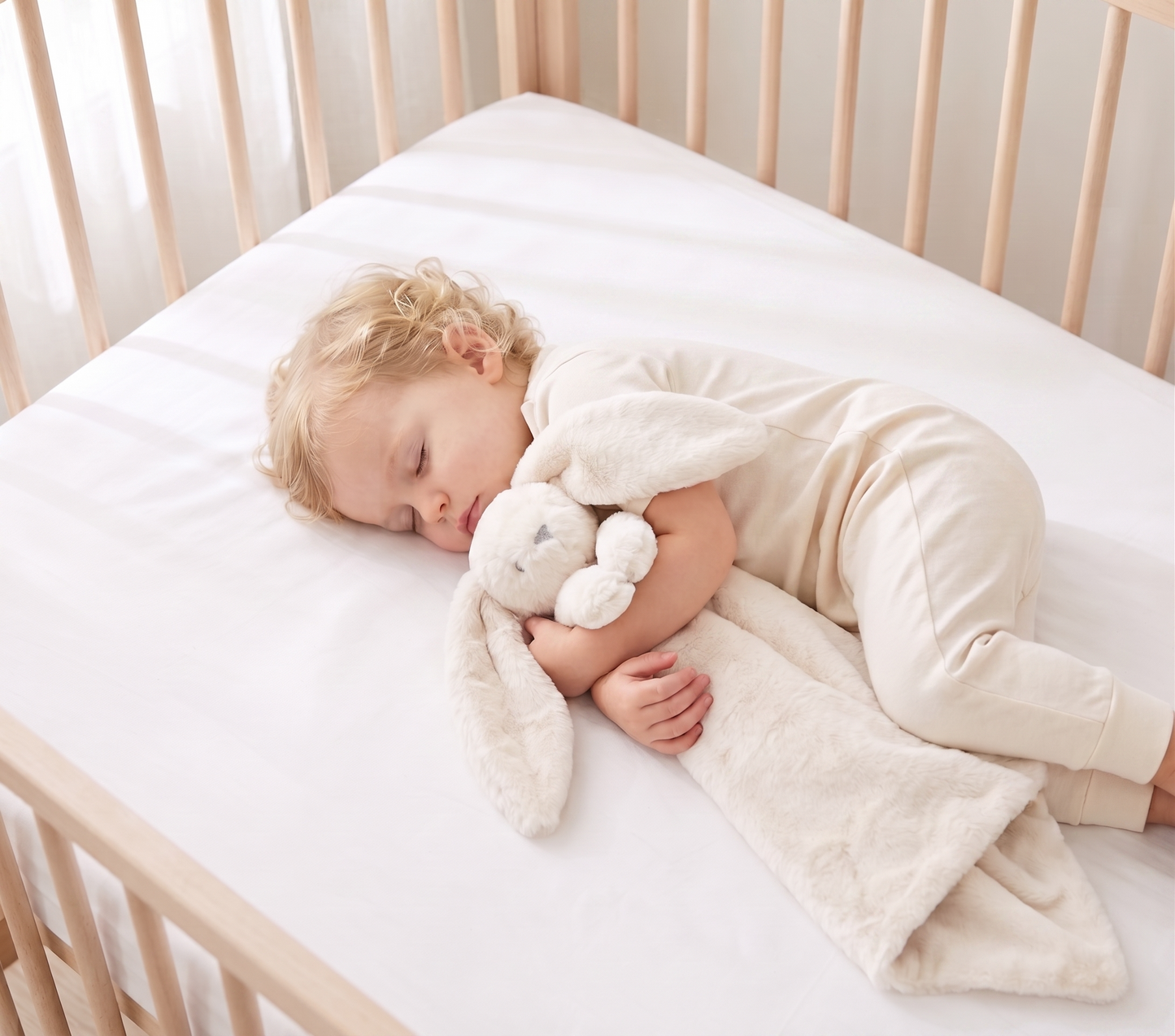 Ivory plush lovey blanket with bunny head and long ears, soft and cuddly for infants.