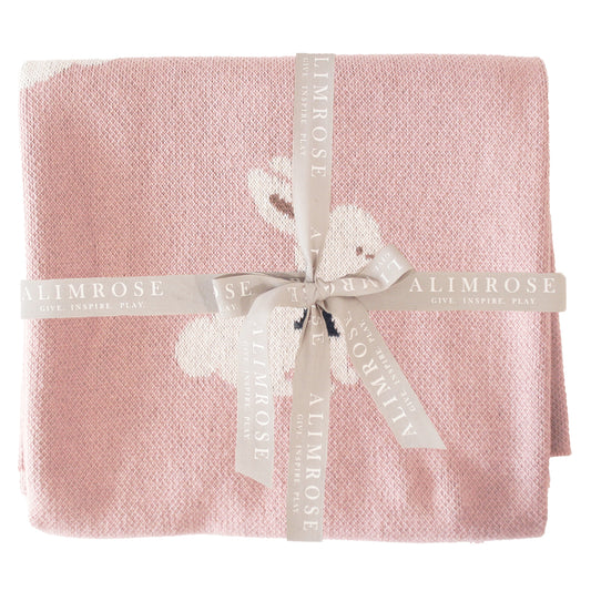 Soft pink knitted baby blanket with a white bunny design, tied with a white Alimrose ribbon.