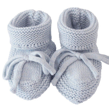 Light blue knitted baby booties with folded cuffs and tied front bows, sized 0-6 months.