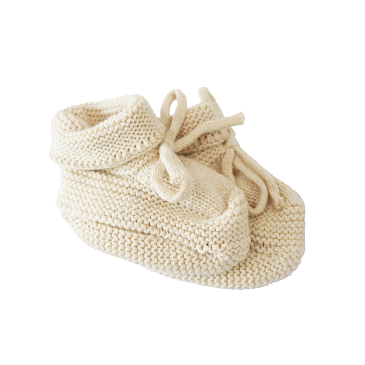Soft cream-colored knit baby booties with folded cuffs and tie closures for 0-6 months.