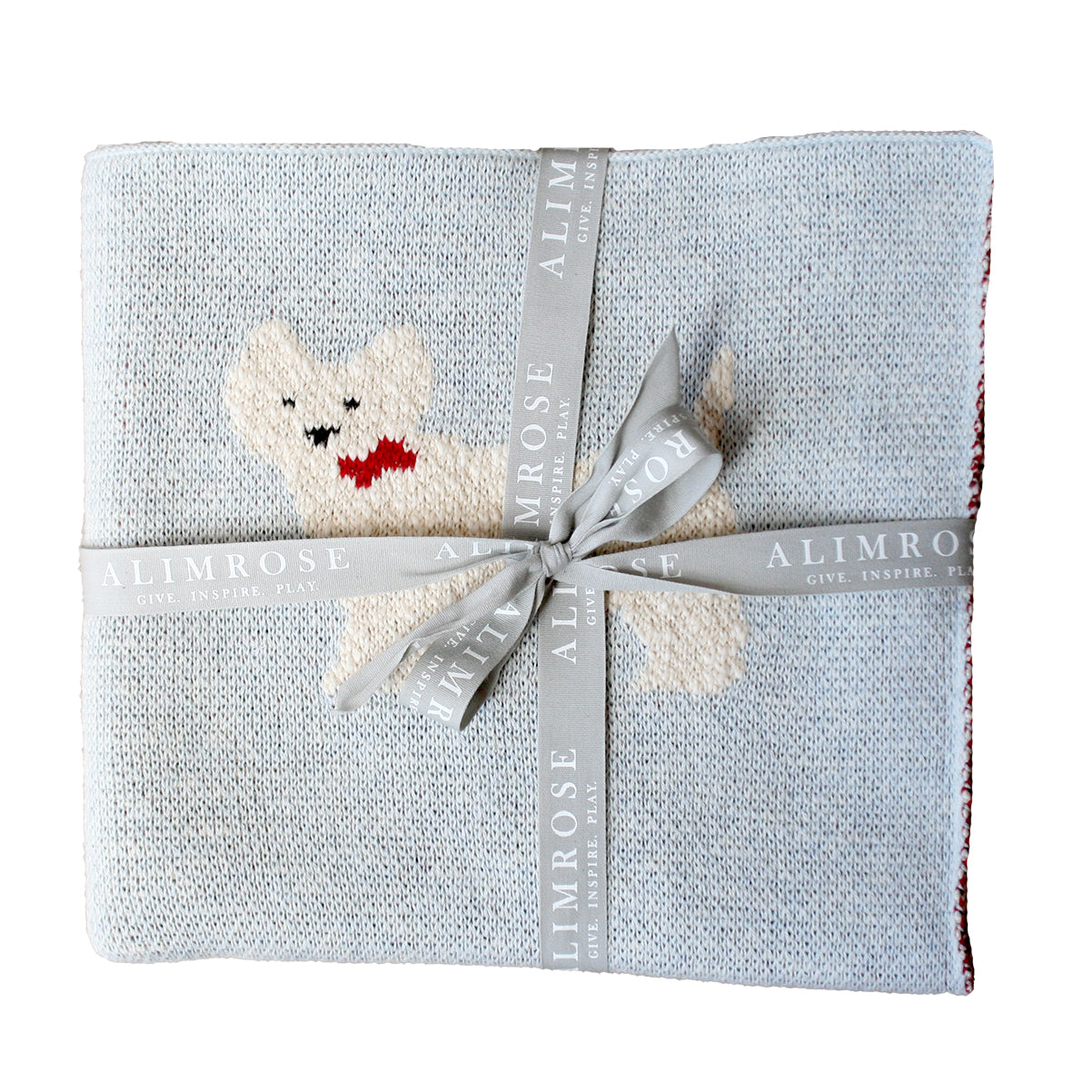 Folded blanket with a knitted dog toy and Alimrose ribbon on a white background