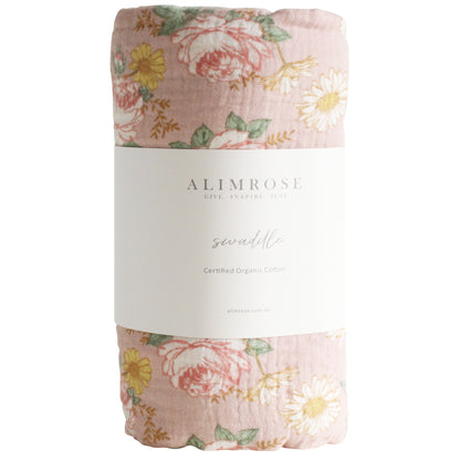 Pink muslin swaddle with English garden floral print featuring roses and daisies.