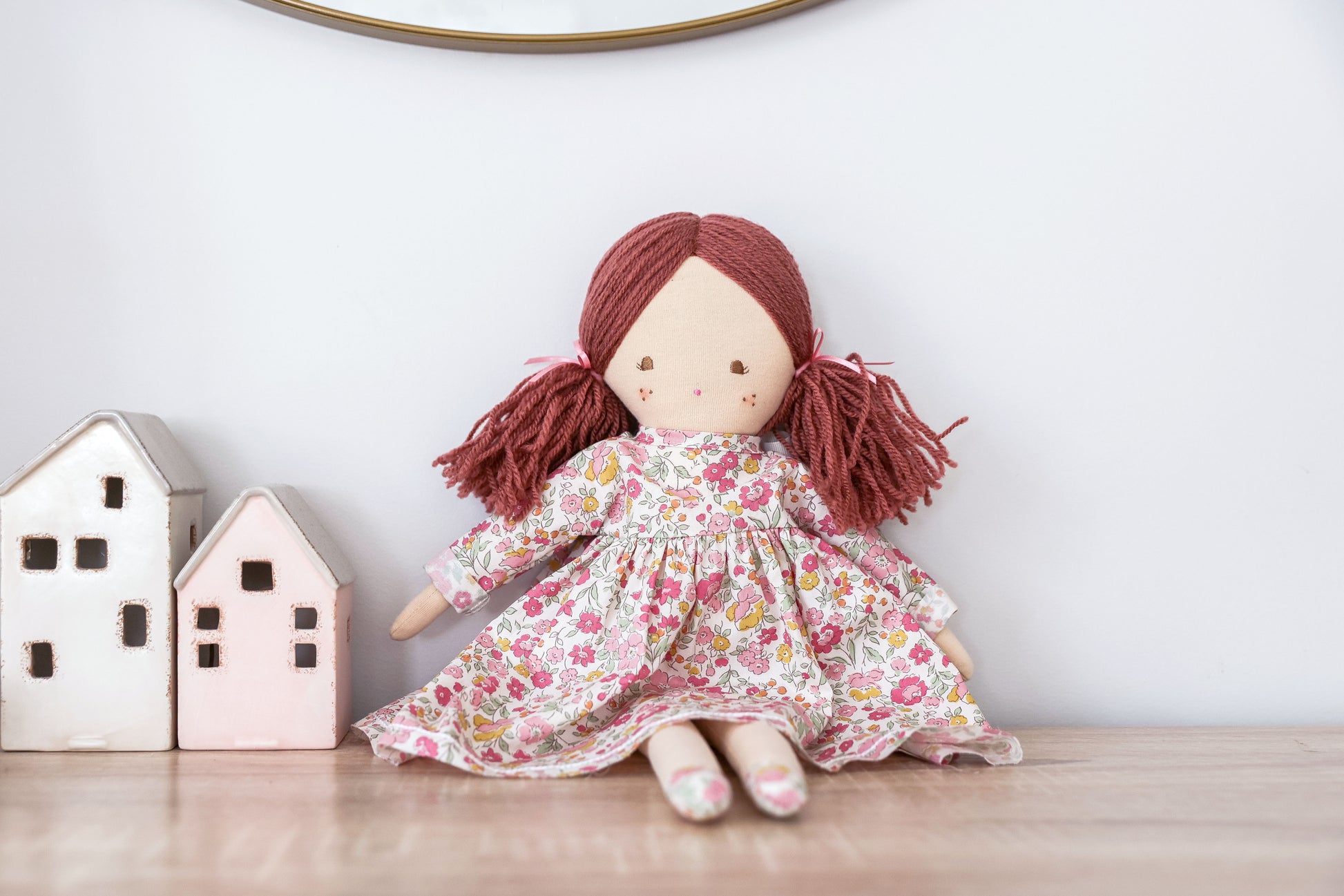 45cm cloth doll with red yarn hair in pigtails, wearing a floral pink and purple dress.
