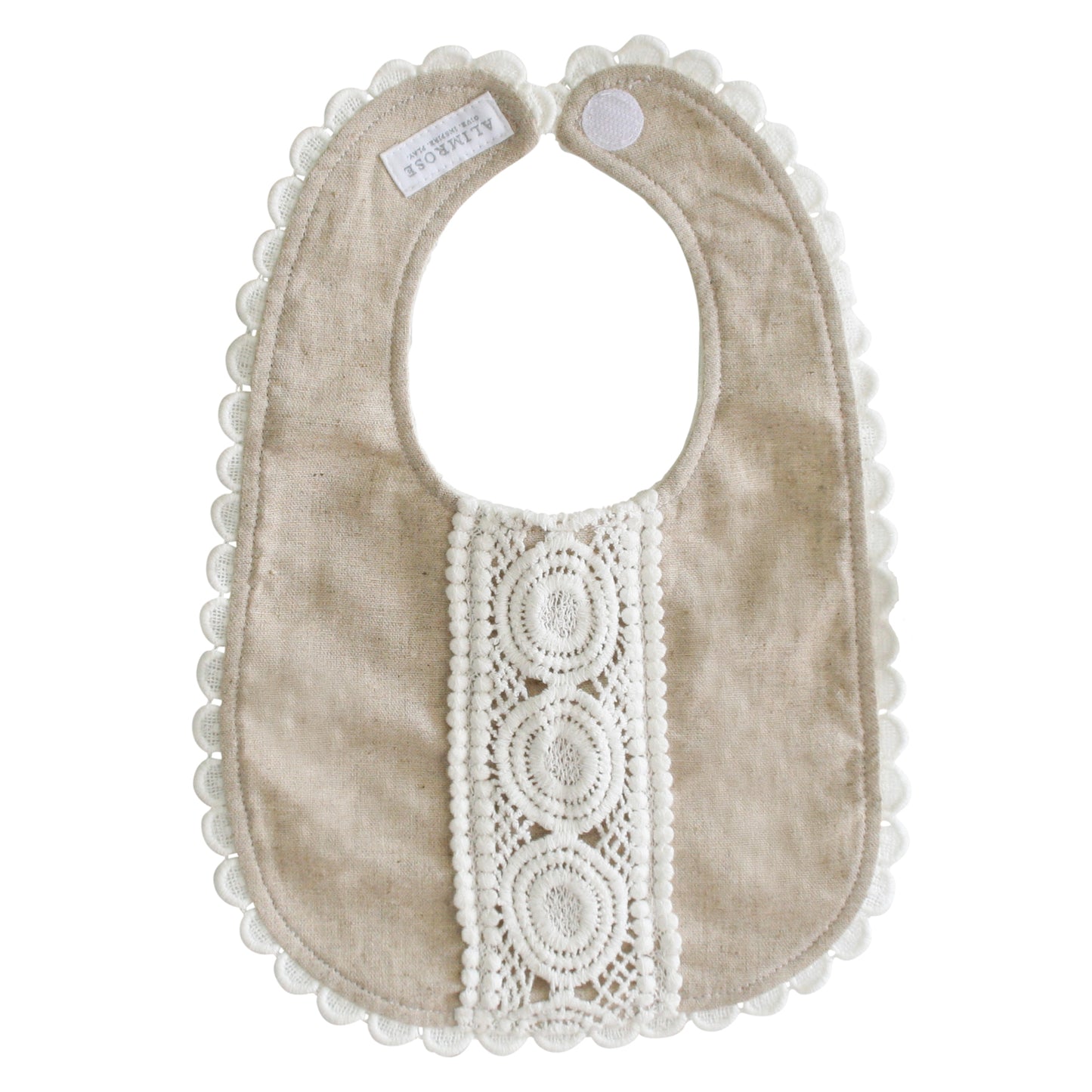 Natural linen baby bib with scalloped edges and intricate white lace detailing down the center.