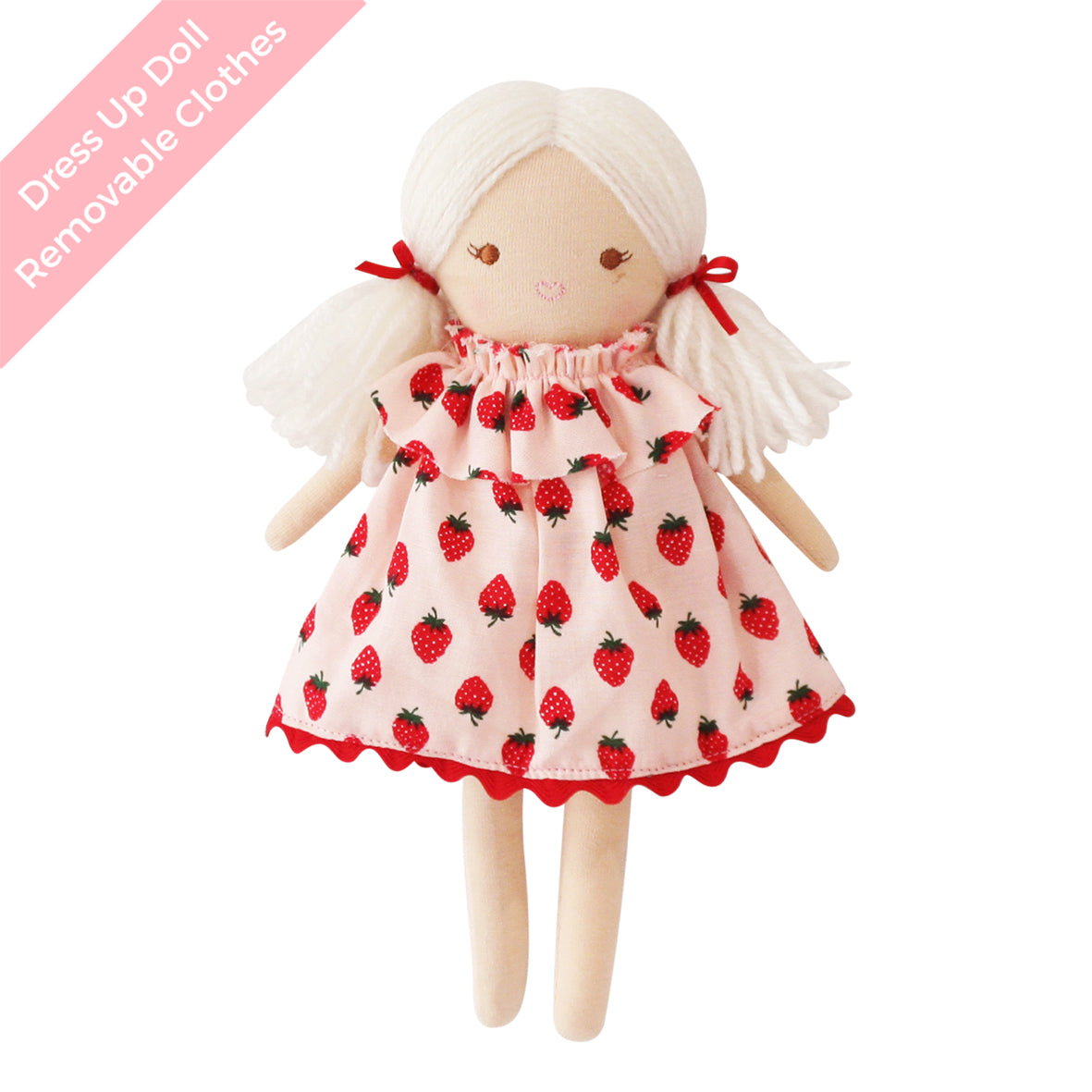 Cloth doll with white yarn hair tied in pigtails wearing a pink strawberry-printed dress with red trim.