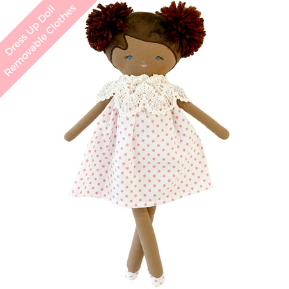 Cloth doll with brown skin, red yarn hair in pom-poms, wearing white dress with red polka dots and lace collar.