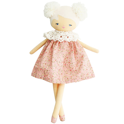 Cloth doll with cream skin, white yarn hair in two puffs, wearing pink floral dress with white lace collar.