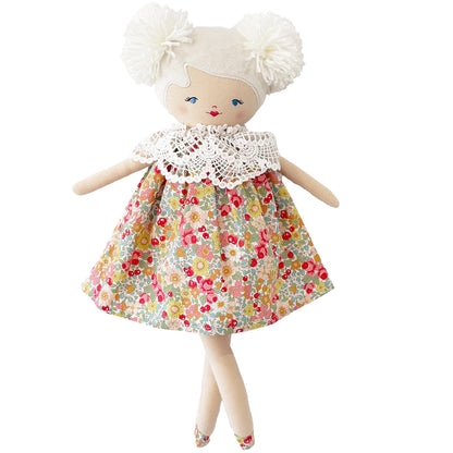 Fabric doll with white yarn hair in two puffs, floral dress with lace collar, and embroidered face.