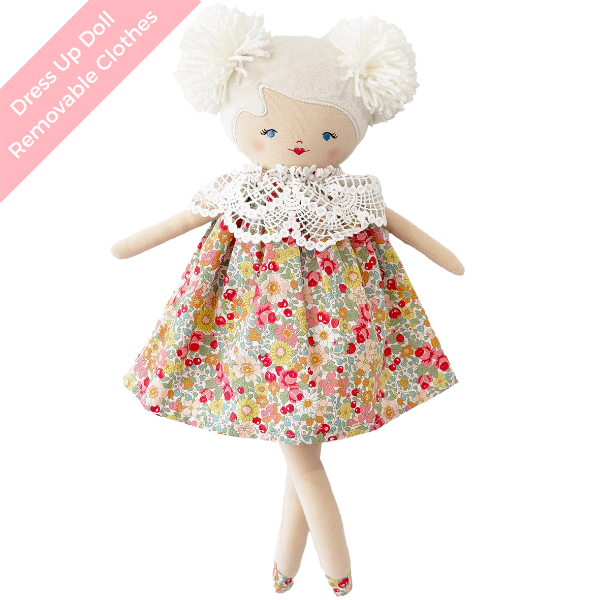 Cloth doll with yarn hair in two pom-poms, blue embroidered eyes, floral dress with white lace collar, soft fabric limbs.