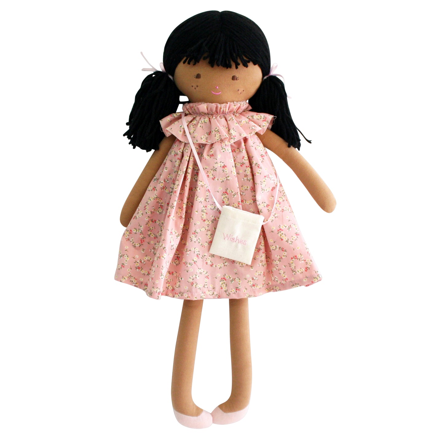 Soft fabric doll with black pigtails wearing a pink floral dress and small white purse.
