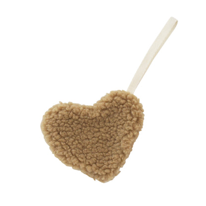 Caramel sherpa heart-shaped plush comforter with attached cream loop handle.