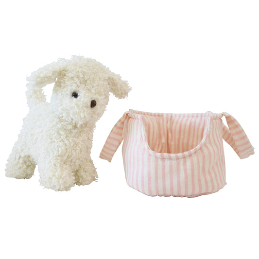 Fluffy cream-colored plush puppy with black eyes beside a soft pink and white striped fabric carrier with handles.