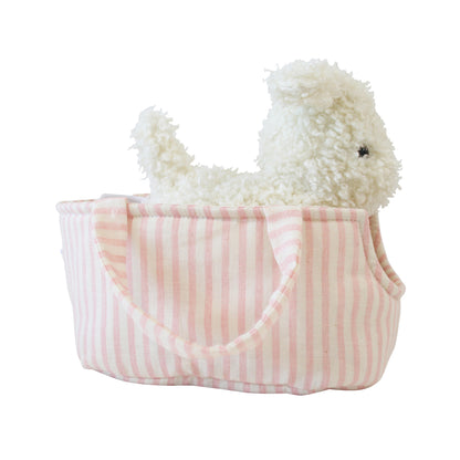 White fluffy plush puppy sitting inside a soft pink and white striped fabric carrier with handles.