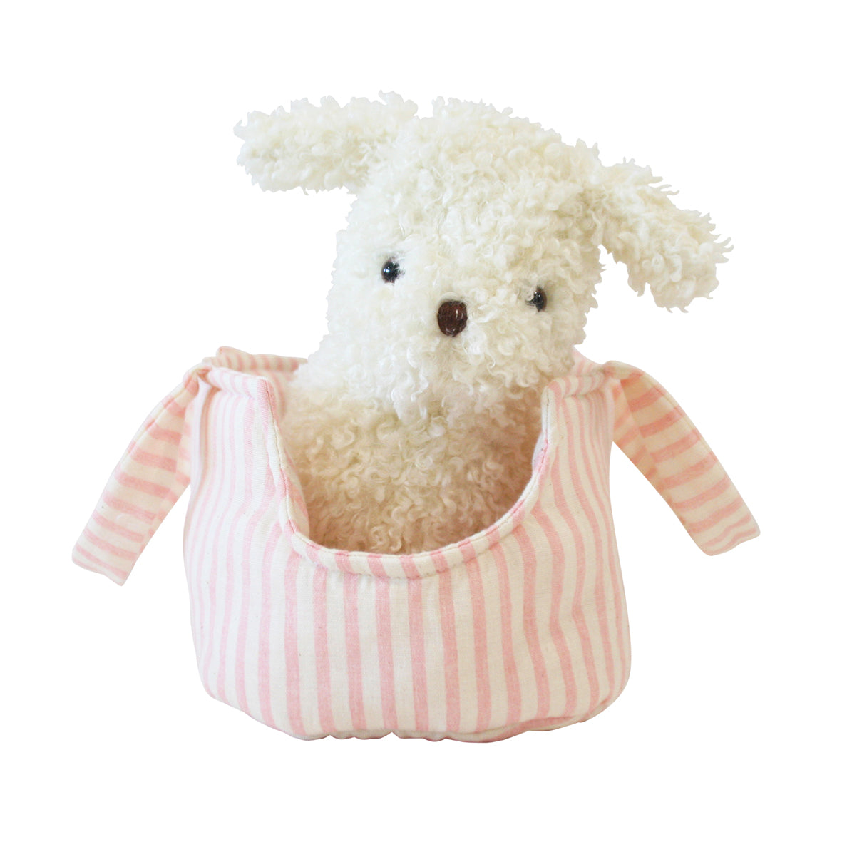 White curly plush puppy with black eyes and nose sitting inside a pink and white striped fabric carrier with handles.