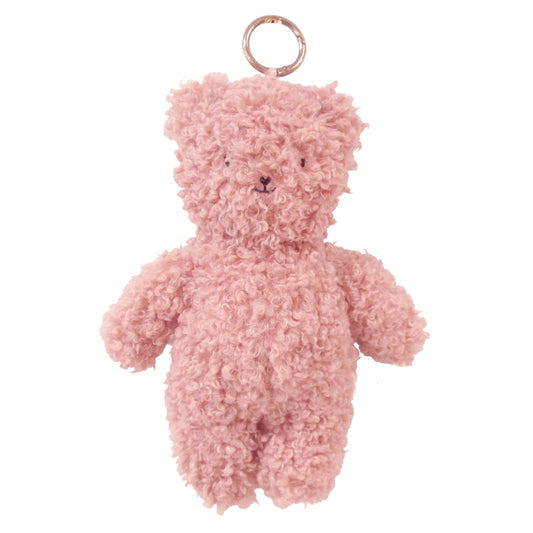 Small fluffy pink teddy bear bag charm with curly soft fur and a metal keyring attached to the head.