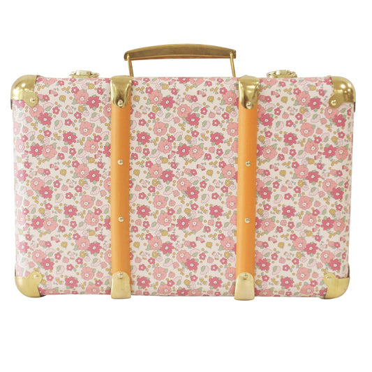 Vintage-style suitcase with pink and white floral print, tan leather straps, and brass corner protectors.